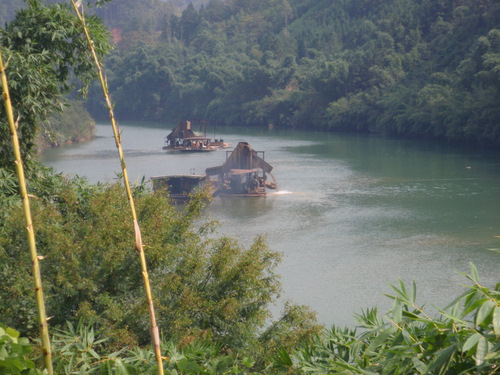 Dredging the river for construction gravel.